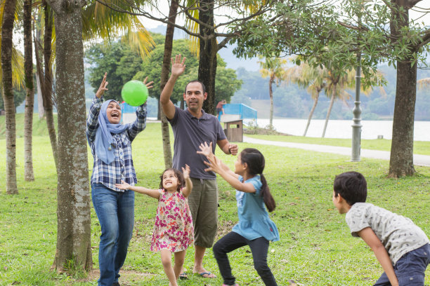 快乐的父母和兴奋的孩子们在公园里玩耍图片下载