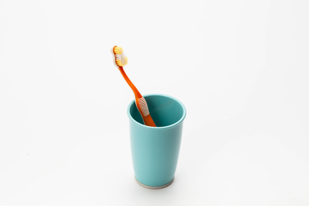 牙刷放在塑料杯中，白色背景上隔离图片下载