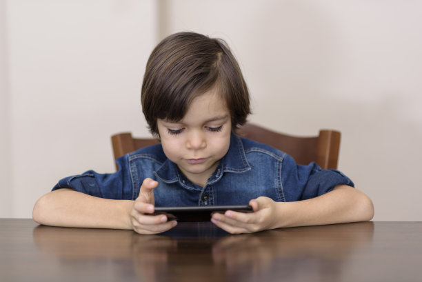 男孩玩电子设备图片下载