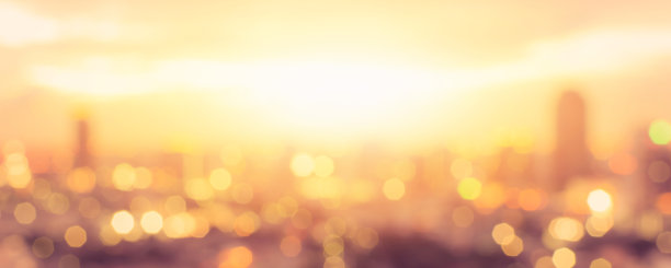 夏天的太阳模糊金色小时天空日落与城市屋顶视图背景城市景观办公大楼景观模糊的城市灯光天际线散景晚会图片下载