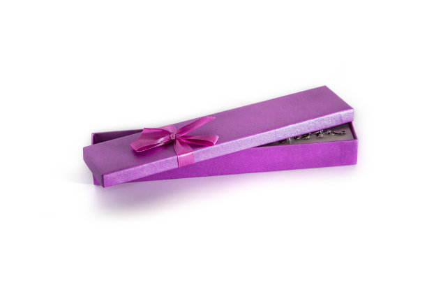 粉紫色礼盒与红色蝴蝶结在美丽的风格和手镯在白色的背景。婚礼理念，爱情日，礼物象征。图片下载