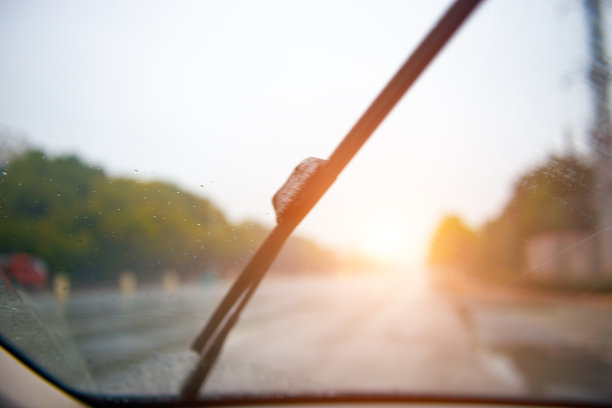 下雨天在汽车内拍摄的虚化公路及玻璃上的水滴图片下载