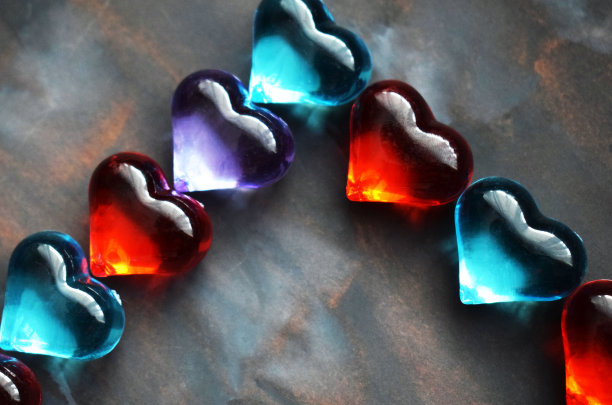 彩色背景上的透明玻璃心。心形的框架。图片下载