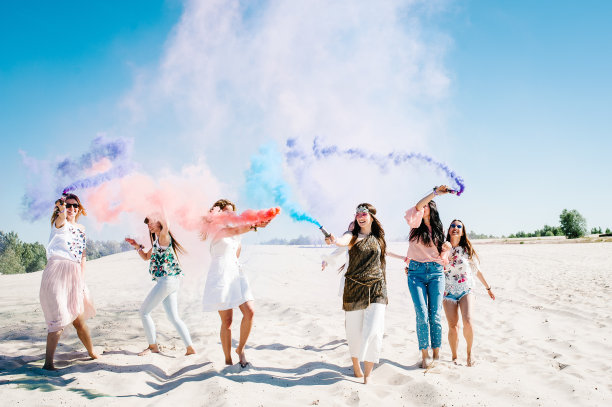 美丽快乐时尚性感的年轻女孩站，去，跑，跳在海滩上，举起彩色烟雾弹。烧毁。真诚的微笑。波西米亚风格的派对。文本。未婚女子图片下载