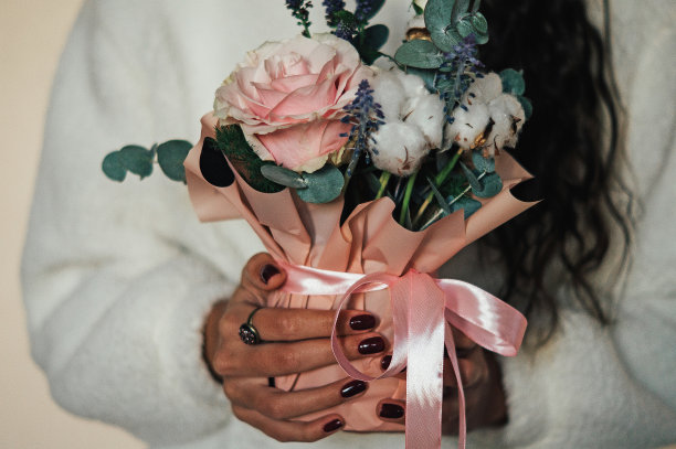 女人拿着漂亮温柔的粉彩鲜花组成的婚礼仪式图片下载