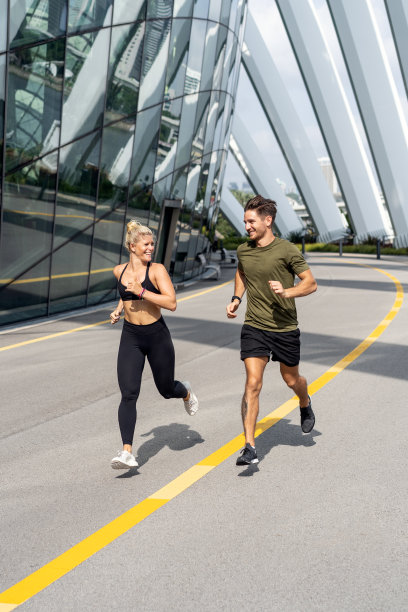 一对漂亮的夫妇在街上奔跑。在户外慢跑图片下载