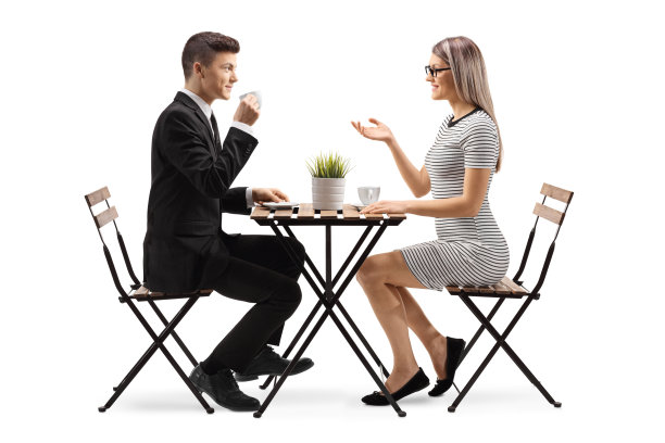 一个穿西装的年轻人和一个年轻女人坐在一起喝着咖啡图片下载