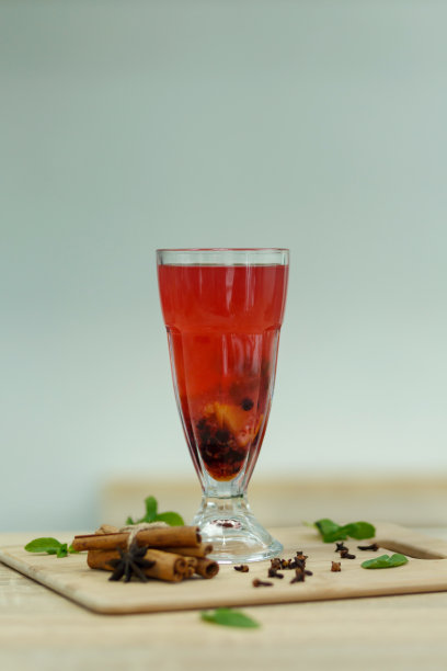 木桌上放着一杯红热的维生素茶。冬季热饮图片下载