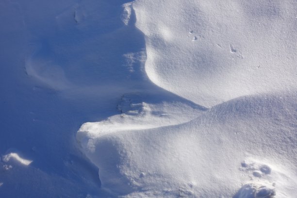 冬天的背景。雪堆上的光影。抽象的背景图片下载