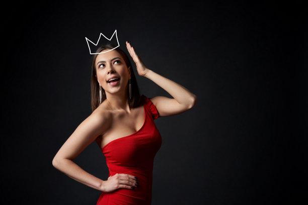 身着红色长裙的惊讶女人，头顶上还顶着她的皇冠图片下载