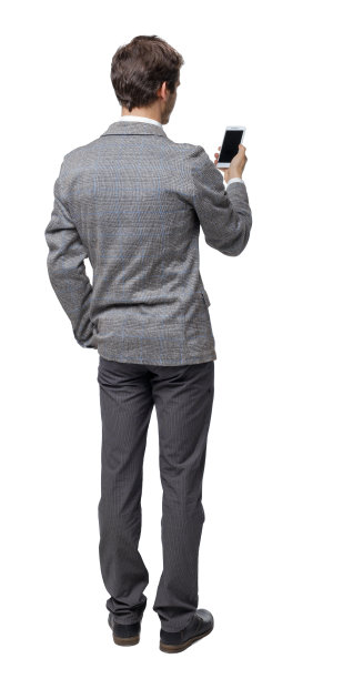 一位正在研究智能手机的商人的背影。图片下载