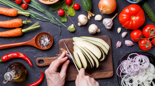 照片上的新鲜蔬菜，香槟，切菜板，油，刀，茄子，厨师的手图片下载