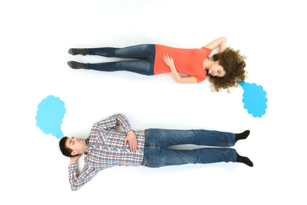 睡着的一对躺在对话标志旁边。从上面的观点图片下载