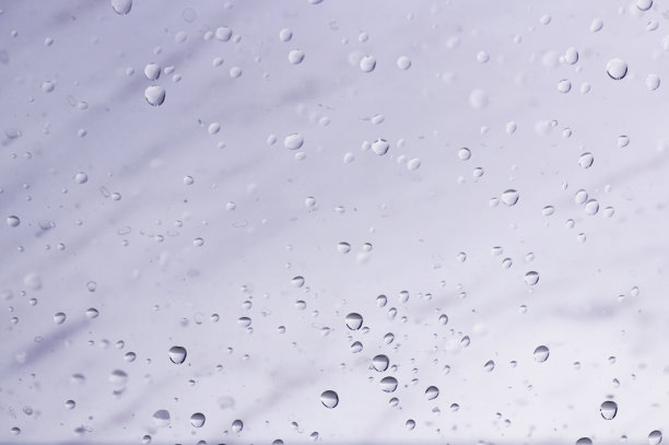 几滴水滴在玻璃杯上。丰富多彩的抽象背景。美丽的纹理。背景图像设计。图片下载