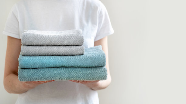 成品洗衣的概念。裁剪照片的漂亮和和平的女士与毛巾在手里站在明亮的光flat内部图片下载