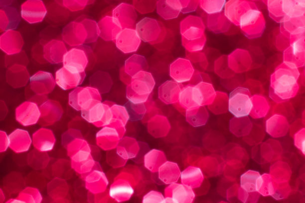 红色闪烁的节日背景与散景灯。庆祝概念的节日和周年素材图片