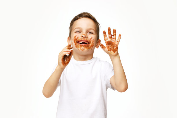 小男孩的脸和手都在巧克力里图片下载