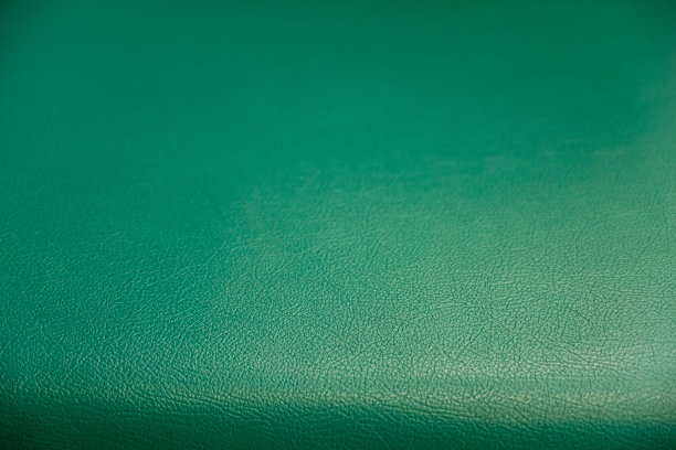 表面图案绿色合成皮革纹理背景，纹理背景的柔软和现代的沙发靠背图片下载