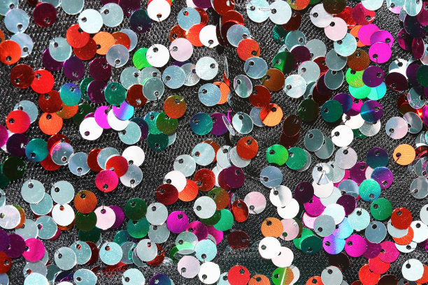 节日美丽多彩的背景为生日、婚礼。带有彩色闪光亮片的针织面料的纹理图片下载