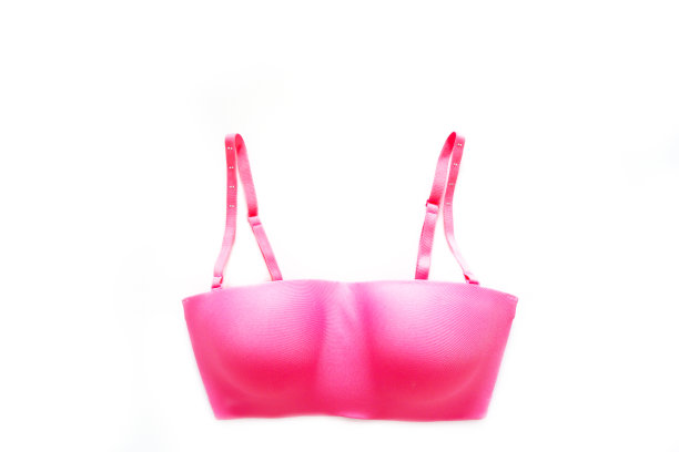 美丽的粉红色内衣被隔离在白色的情人节。一套附属内衣(比基尼)织物，复制空间。女人是蕾丝性感胸罩(胸罩)在白色背景，顶视图。图片下载
