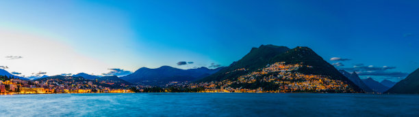 在瑞士的卢加诺湖对面的老城卢加诺日落视图图片下载