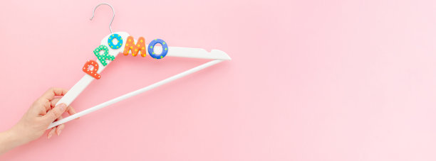 粉色背景上印有促销文字的白色衣架图片下载