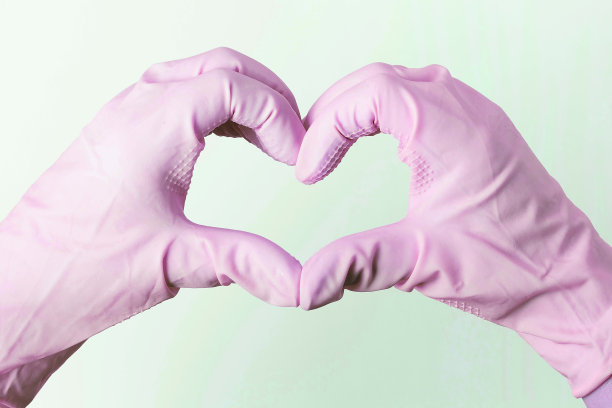 双手戴着橡胶手套，在白色的背景上形成一个心的形状图片下载
