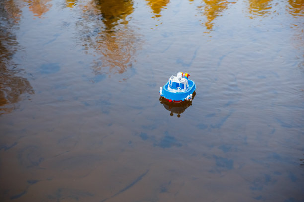 玩具船在平静的溪水上航行图片下载