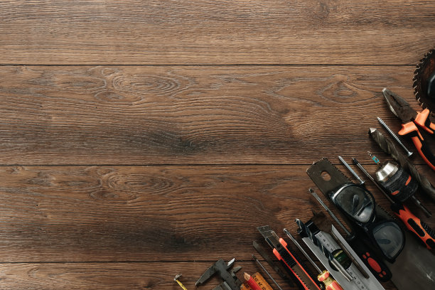 在棕色木制背景上的建筑工具。从以上观点。背景图片,屏幕保护程序。施工、维修、施工、生产、设计的概念。副本的空间。图片下载