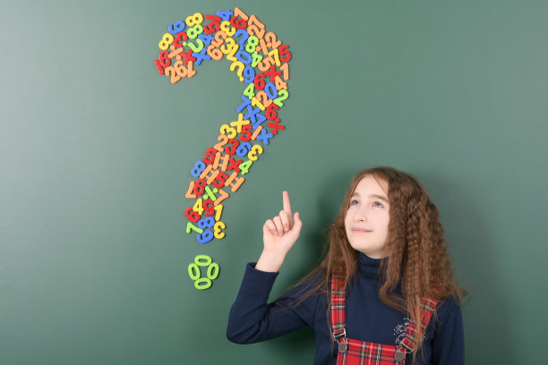 微笑的小女孩在绿色学校董事会。图片下载