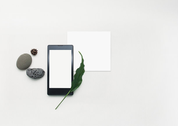 模拟手机创意布局。平板智能手机，空白便条纸。白色背景。空白模拟纸和屏幕智能手机。以海石、绿叶为商务休闲理念。图片下载