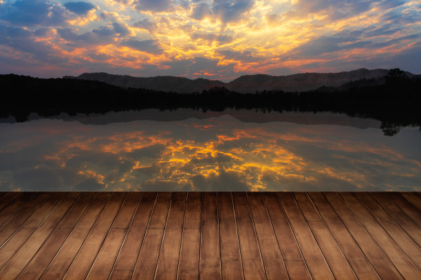 清晨日出与湖泊和山脉自然和古老的木地板背景。图片下载