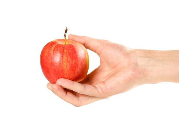手里拿着一个红苹果。关闭了。在白色背景上隔离图片下载