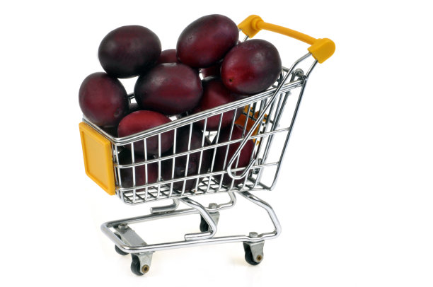 白色背景下超市手推车里的李子图片下载