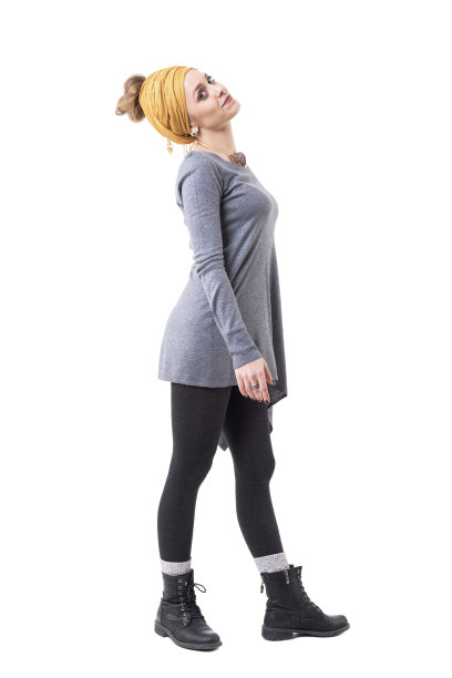 侧面的年轻快乐可爱的女人与黄色头巾行走和微笑的镜头图片下载