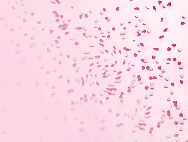 节日的粉红色背景和心形的红色亮片。图片下载