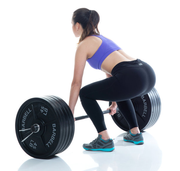 美丽的女性在运动服装举起重物，后视图图片下载