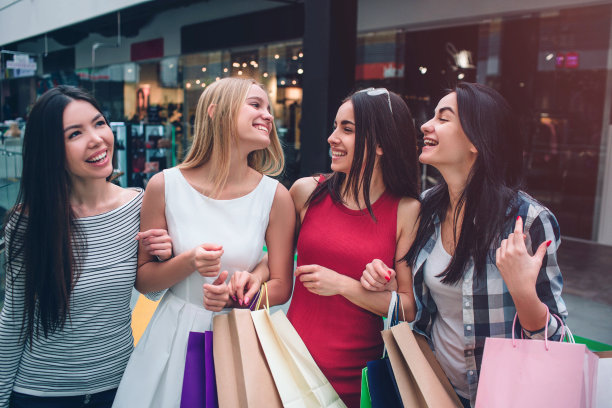 开朗漂亮的女孩在一起玩得很开心。他们互相看着，微笑着。一个亚洲女孩正仰面看。图片下载
