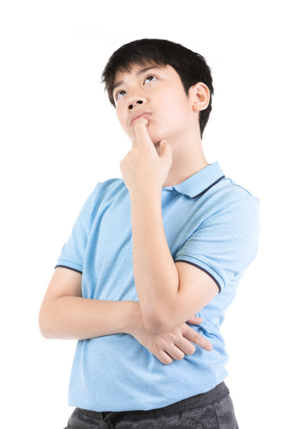 年轻的亚洲男孩思考白色的背景，半长情绪的肖像少年男孩穿着蓝色t恤。有思想的少年，被孤立在白色的背景下。英俊聪明认真思考的孩子。图片下载