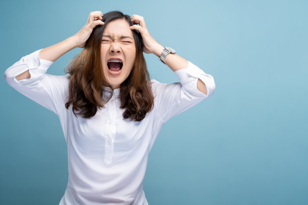 愤怒的女人在蓝色背景下尖叫图片下载