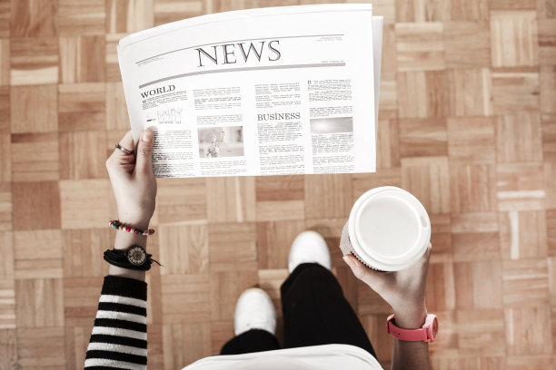 拿着报纸和咖啡在办公室散步的女人图片下载