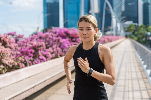 年轻的亚洲女人在城市的街道上奔跑图片下载