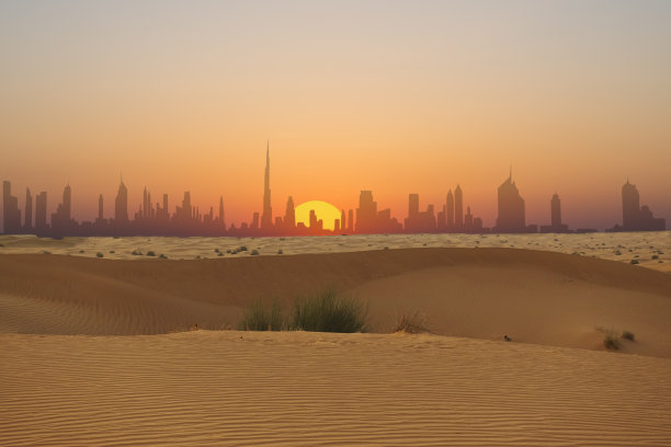 从阿拉伯沙漠看到的迪拜天际线或城市日落轮廓图片下载