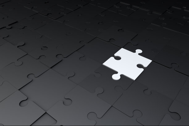 一个白色的拼图在黑暗的拼图上图片下载