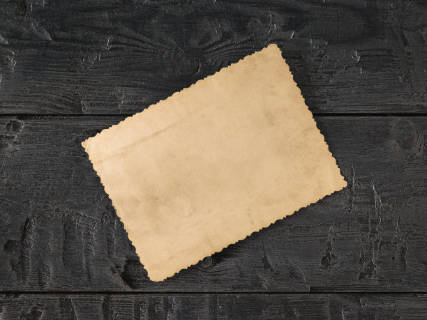 深色木桌上放着一张翻过来的旧照片。家庭的主题。从上往下看。图片下载