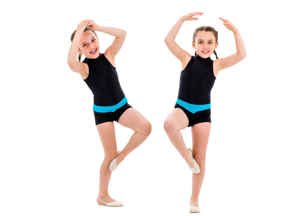 双胞胎女孩在白色背景下练习艺术体操。图片下载