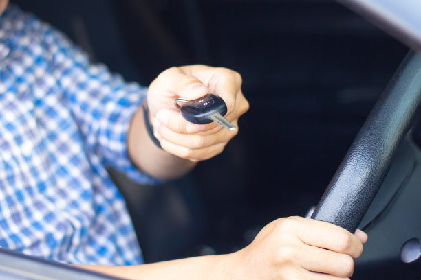 一个人坐在车里，向经销商展示车钥匙。汽车业务，汽车销售，汽车租赁消费主义业务，人们运输汽车服务或汽车保险概念。图片下载