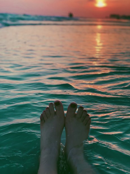 在日落的时候脚在海里图片下载