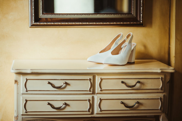 木制架子上的白色新娘鞋。复古/复古概念。图片下载