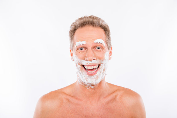 英俊有趣的男人，下巴和眉毛上有剃须泡沫图片下载